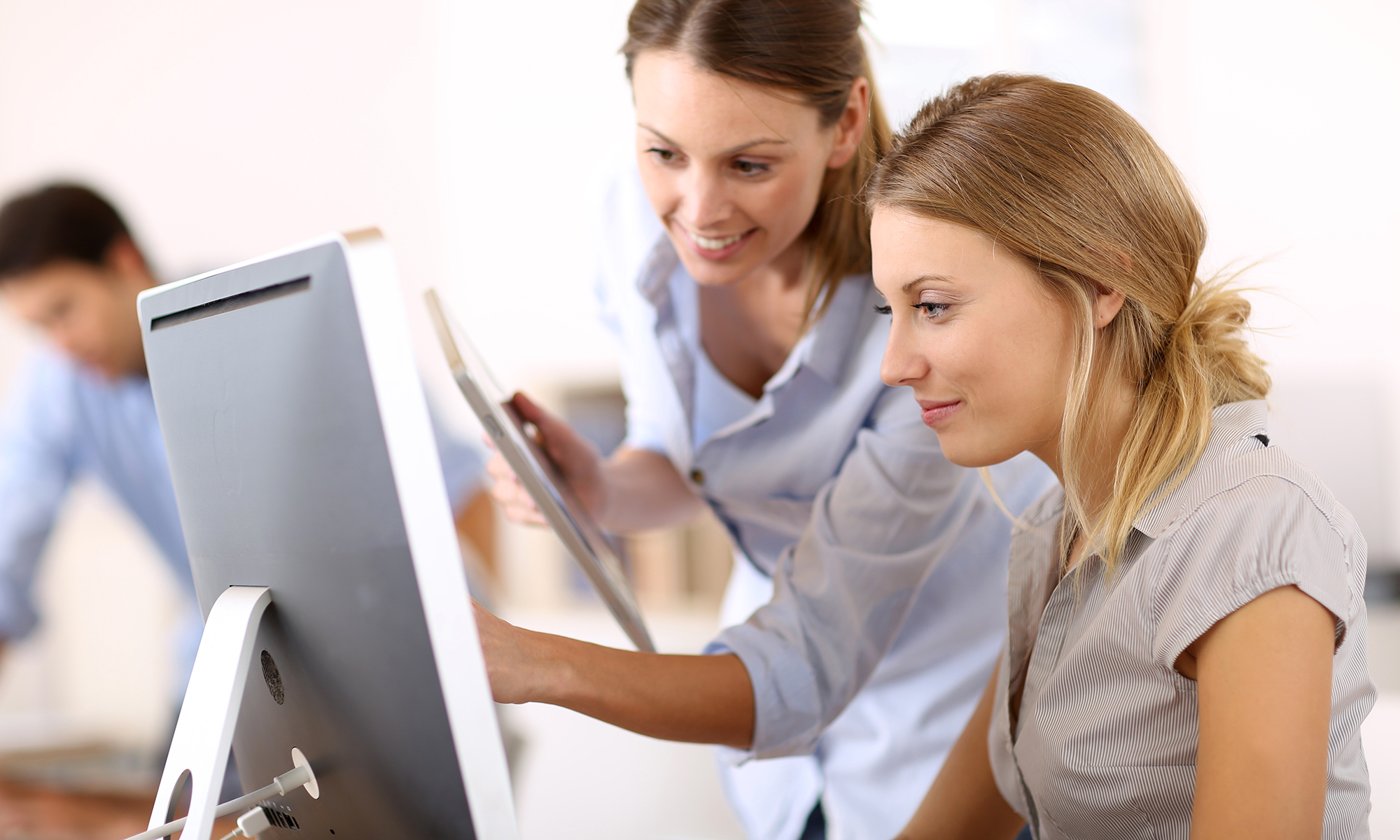 This is a picture of two women looking at a computer to choose a crowdfunding site for their next fundraising project.